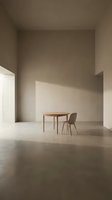Minimalist interior space featuring wooden round table and chair in empty room with natural light, suitable for modern design, architecture visualization, and contemporary furniture showcasing.