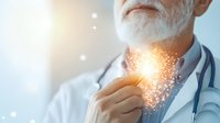 Senior male doctor with white beard holding glowing light particles in hand against blue background, representing medical innovation and healing energy.