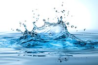 Dynamic water splash with droplets and waves frozen in motion against light blue background, suitable for beverage, wellness, and environmental design projects.