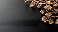 Delicate copper metallic flowers and leaves arrangement on dark background with selective focus and shallow depth of field creating moody atmosphere.