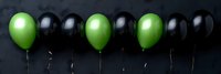 Festive green and black balloons arrangement on dark background for party decorations, celebrations, events, and holiday designs.