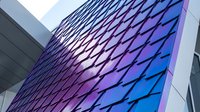 Modern architectural facade with geometric diamond pattern in vibrant purple and blue gradient, contemporary building exterior design for corporate and commercial projects.