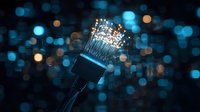 Glowing fiber optic cable with illuminated ends against dark background with blue bokeh lights, showcasing digital connectivity and data transmission technology.