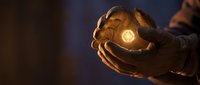Hands cupping glowing light orb in darkness symbolizing hope, protection, energy and spiritual guidance for meditation and wellness concepts.