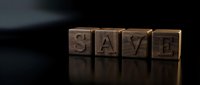 Wooden blocks spelling SAVE on a dark reflective surface, conveying financial savings, investment, and money management concepts.