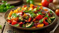 Fresh Mediterranean salad with grilled vegetables, colorful bell peppers, zucchini, tomatoes, red onions and herbs served on rustic wooden table, healthy eating.