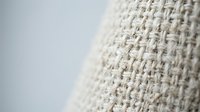 Natural beige burlap fabric texture with woven fibers pattern for rustic design projects and craft backgrounds.
