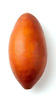 Fresh ripe mango with smooth orange-red skin and elongated oval shape, isolated on white background for food and nutrition content.