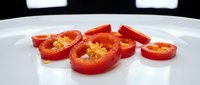 Fresh red bell pepper slices with seeds displayed on white plate for cooking, food preparation, healthy eating, and culinary design projects.