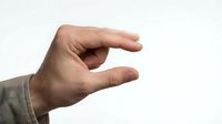 Male hand with light skin tone gesturing small size or measuring distance against white background, suitable for business presentations, tutorials, and educational materials.