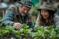 Senior couple enjoying gardening together in their vegetable patch, sharing joyful moment while tending to fresh green leafy plants, representing active retirement and sustainable lifestyle.
