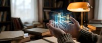 Hands holding holographic digital building model with glowing blueprints in cozy study room with books and warm lighting for architecture and technology concepts.
