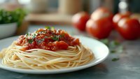 Delicious spaghetti pasta with rich tomato sauce and fresh herbs served on white plate in cozy kitchen setting for culinary content and recipe blogs.