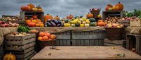 Autumn harvest display with pumpkins, gourds and seasonal vegetables in rustic wooden crates for fall decorating and seasonal marketing campaigns.