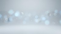Soft blue bokeh lights floating on gradient background creating dreamy atmosphere for presentations and design projects.
