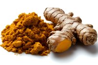 Fresh turmeric root and ground powder spice on white background, aromatic ingredient for cooking Asian cuisine and healthy supplements.