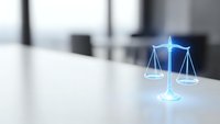 Digital justice scales hologram on modern office desk with blurred corporate background. Legal technology concept for law firms and judicial system innovation.
