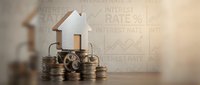 Real estate investment and mortgage concept with miniature house model on stacked coins, financial growth chart background. For property, banking, finance.