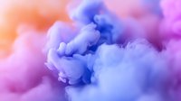 Ethereal swirling smoke clouds in vibrant purple, blue and pink hues create dreamy atmospheric background with soft gradient transitions and delicate flowing textures.