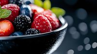 Fresh mixed berries in bowl with strawberries blueberries raspberries and blackberries for healthy breakfast dessert or smoothie ingredients.