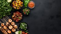 Grilled shrimp skewers with fresh vegetable salsa, herbs and dipping sauce on dark background. Mexican or Mediterranean appetizers served with colorful sides.