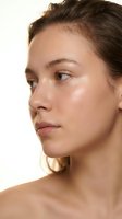 Woman with brown hair and fair complexion shown in profile, displaying natural skin texture and minimal makeup for skincare, cosmetics, and beauty product advertising.