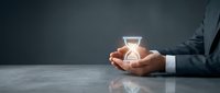 Businessman in formal suit holding glowing light bulb symbol, representing innovation, creativity, and new business ideas for entrepreneurship and startup concepts.