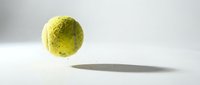 Bright yellow tennis ball with textured surface casting shadow on white background, isolated for sports equipment design and athletic promotional materials.