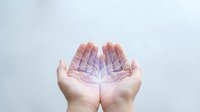 Caucasian hands holding glowing purple leaf on white background, symbolizing growth, sustainability, and eco-friendly innovation for environmental and business concepts.