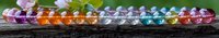 Colorful healing crystals and gemstones arranged in line on rustic wooden surface with soft natural bokeh background, spiritual wellness concept.