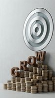 Business growth target concept with wooden letters spelling GROW on stacked coins leading to bullseye target for financial success and investment goals.