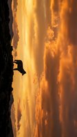 Rock climber silhouette against dramatic orange sunset sky with clouds. Adventure sports and outdoor recreation concept for motivation and achievement themes.