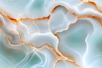 Luxurious mint green agate mineral texture with golden veins creating organic flowing patterns on polished stone surface, macro photography closeup.