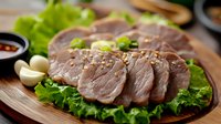 Juicy sliced pork tenderloin garnished with sesame seeds and fresh herbs, served on lettuce leaves with garlic and dipping sauce on rustic wooden board.