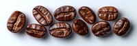 Fresh roasted coffee beans arranged in row on light background, macro shot showing rich brown color and detailed texture of arabica beans.