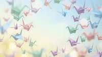 Colorful origami paper cranes floating on soft pastel background creating dreamy artistic composition for meditation, creativity and peaceful design projects.