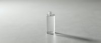 Clear glass bottle with dropper cap on neutral gray surface, isolated for cosmetic, skincare, or pharmaceutical product packaging design and branding mockups.