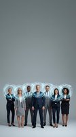 Diverse group of seven business professionals in formal attire standing together with glowing digital head icons, representing corporate teamwork, innovation and connected workforce for business solutions.