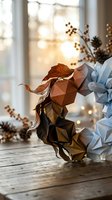 Geometric paper craft autumn leaves arrangement with warm bokeh lighting on rustic wooden surface for seasonal home decor and DIY projects.