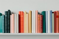 Colorful collection of hardcover books arranged on white shelf, showcasing spines in teal, coral, yellow, pink, and blue tones for home decor or library display.