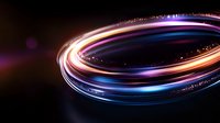 Glowing spiral light trails with blue, orange and purple colors swirling in dark background creating dynamic motion effect for abstract technology designs.
