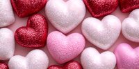 Glittery red, pink and white heart decorations on pink background. Romantic festive pattern for Valentine's Day cards, wedding invitations and love concepts.