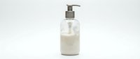 Pump dispenser bottle filled with white liquid soap or lotion isolated on white background, ready for product mockups and cosmetic packaging designs.