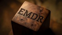 Vintage cork stopper with EMDR letters engraved on surface, close-up macro photography showing texture and detail for therapy and mental health concepts.