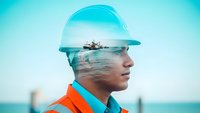 Double exposure portrait of marine engineer in safety helmet with offshore oil rig platform overlay, industrial maritime concept for energy sector.