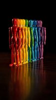 Colorful rainbow skeleton figures arranged in row on reflective surface against black background for Halloween decoration and spooky themed designs.
