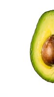 Fresh avocado half with pit and water droplets on white background, suitable for food, nutrition, healthy eating, and culinary content.