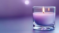 Purple scented candle burning in clear glass holder creating warm ambient lighting for relaxation, meditation, aromatherapy and spa treatments at home.