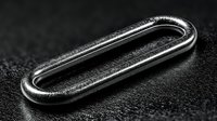 Metal paperclip close-up on dark textured surface showing industrial design and office supply detail for business and organizational concepts.