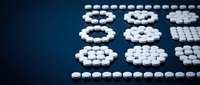 White pharmaceutical pills arranged in numerical digits on dark blue background for medical healthcare and medication concepts.